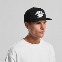 A man wearing a black snapback cap with white 'ARENA STEREO' text on the front, paired with a white crewneck t-shirt, photographed against a neutral light gray background.