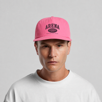 A man wearing a bright pink baseball cap with 'ARENA STEREO' printed in black on the front, paired with a white t-shirt against a light gray background.