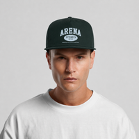 A man wearing a dark green snapback cap with 'ARENA STEREO 33 1/3' printed in white on the front, paired with a white t-shirt against a light gray background.
