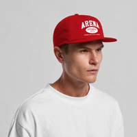 A man wearing a red snapback cap with 'ARENA STEREO' printed in white on the front, paired with a white t-shirt, set against a plain light gray background.