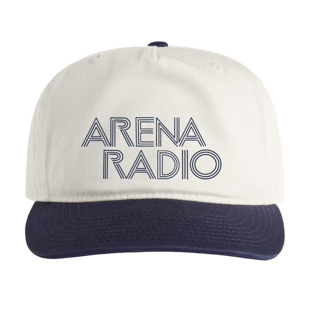 White cap with navy bill featuring 'Arena Radio' text on a white background
