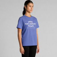 A woman modeling a lapis blue short-sleeve t-shirt with white text reading 'ARENA PURE AMERICAN APPAREL' on the chest, set against a plain gray studio background.